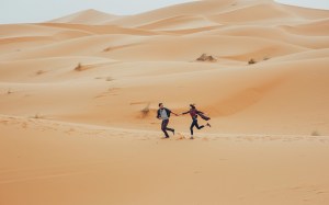 Unique Travel Photos: Man and Woman Running in Desert
